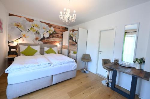 a bedroom with a bed and a table and a chandelier at Enjoyit Velden West in Selpritsch