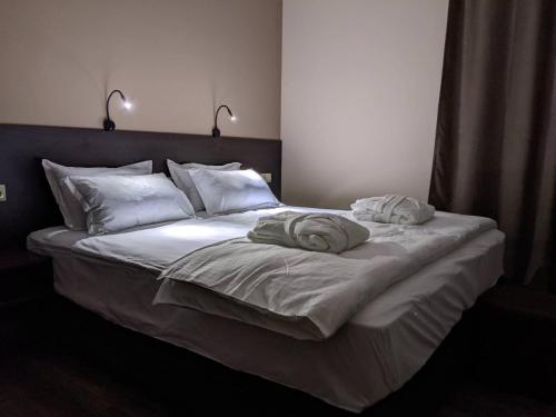 a large bed with two towels on top of it at Milky Way in Stepantsminda