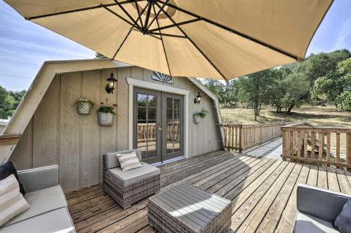a patio with an umbrella and chairs on a deck at Family Home Near Kings and Sequoia National Parks! in Squaw Valley