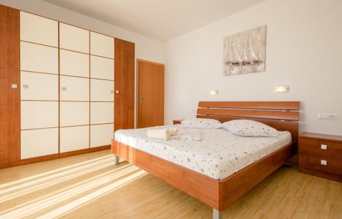 a bedroom with a bed with a stuffed animal on it at Apartments Silvana in Kampor in Kampor