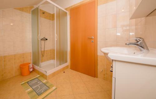 a bathroom with a shower and a sink and a shower at Apartments Silvana in Kampor in Kampor