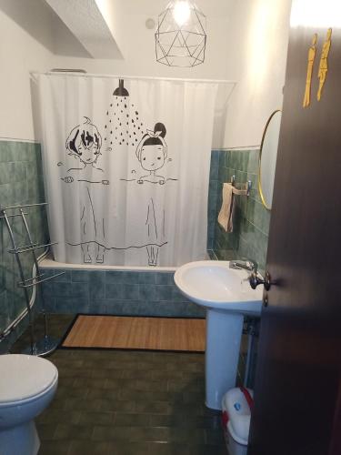 a bathroom with a shower curtain and a sink at Alojamento local Angel`s in Ponte da Barca