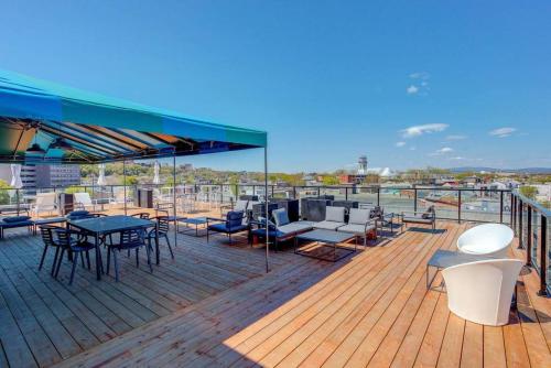 a deck with tables and chairs on a boat at Condo Old Quebec - Gym - AC - Indoor Parking - Rooftop in Quebec City