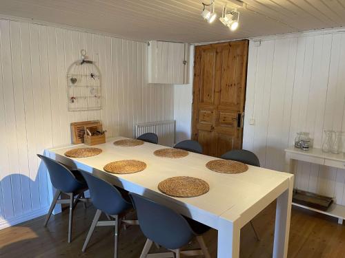 a room with a table with blue chairs and a tableablish at Swedish Adventure in Brograngen