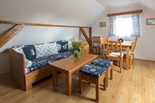 a living room with a couch and a table at Hezká chalupa in Strmilov