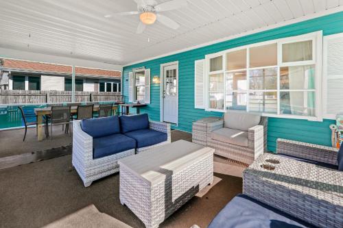 a porch with couches and chairs and a table at Rehoboth Beach Anna B St in Rehoboth Beach