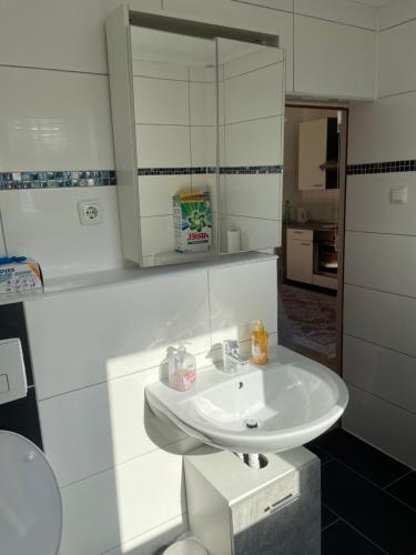 a bathroom with a white sink and a mirror at Ferien - Wohnung In Kassel Waldau Zentral in Kassel