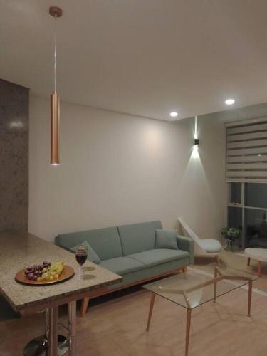a living room with a blue couch and a table at Onkel Inn Apart Suites in La Paz