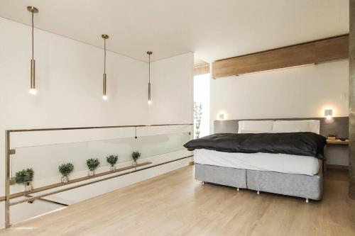 a bedroom with a bed and potted plants on the wall at Onkel Inn Apart Suites in La Paz