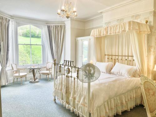a bedroom with a large bed with a canopy at The Buckley Arms in Dinas Mawddwy