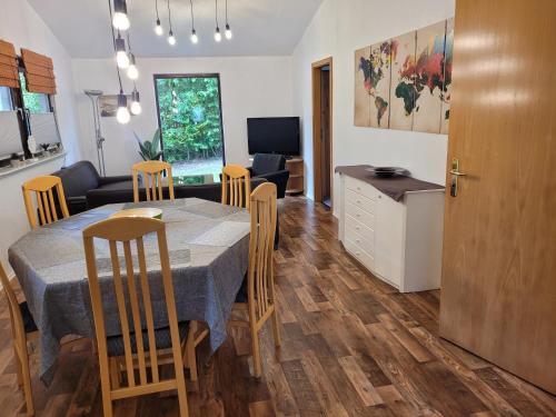 a kitchen and dining room with a table and chairs at Grüne Haus in Vöhl