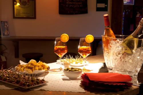 a table with glasses of wine and food on it at Hotel Portavescovo in Arabba