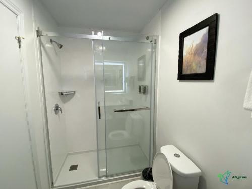 a bathroom with a shower with a toilet and a sink at Glengarry Extended Stays in Truro
