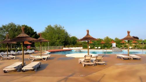 a swimming pool with lounge chairs and umbrellas at Hotel Gudamendi in San Sebastián