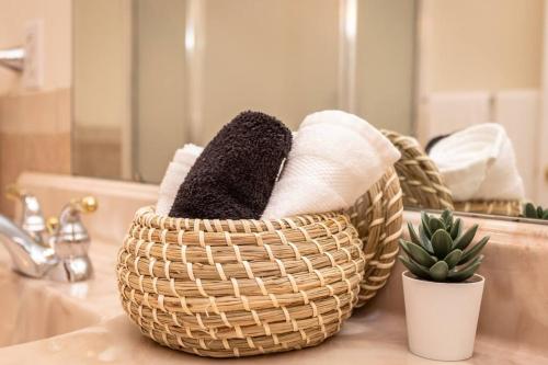 a basket of towels sitting on a bathroom sink at Spacious Family Friendly Home Near Massanutten and National Park in McGaheysville