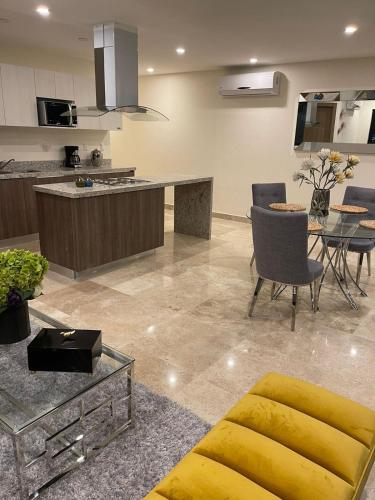 a kitchen and living room with a table and chairs at Central Tower 102 Malecón Mazatlan in Mazatlán