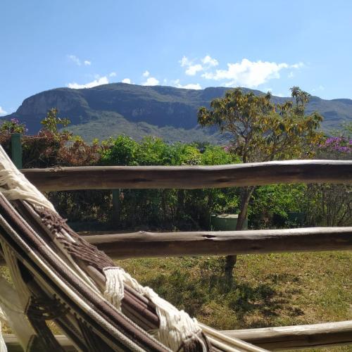 a wooden fence with a view of a mountain at Pousada Morro da Baleia in Alto Paraíso de Goiás