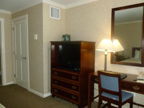 a living room with a television and a dresser at Stoweflake Mountain Resort & Spa in Stowe