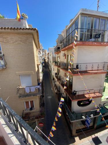 a view of a street between two buildings with flags at Alex Apartments in Benidorm