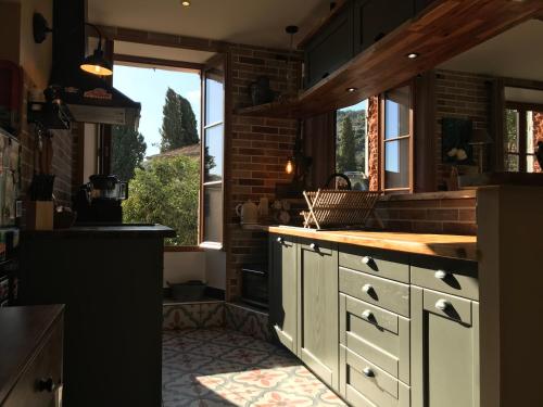 a kitchen with a counter top and a window at La LAZARENCO in Plan-de-la-Tour