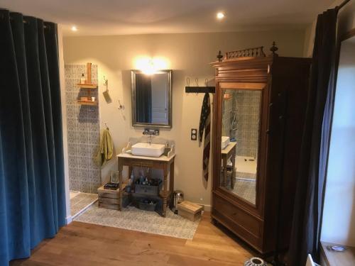 a bathroom with a sink and a mirror at La LAZARENCO in Plan-de-la-Tour