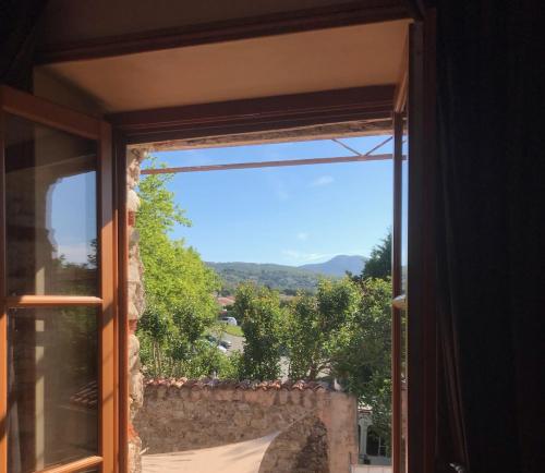 a window with a view of a mountain at La LAZARENCO in Plan-de-la-Tour