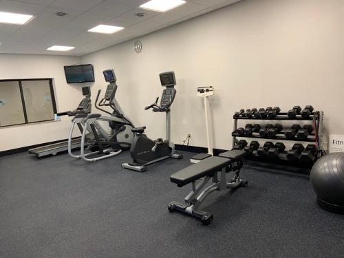 a gym with several treadmills and exercise bikes at Holiday Inn Express Hotel & Suites Hermosa Beach by IHG in Hermosa Beach