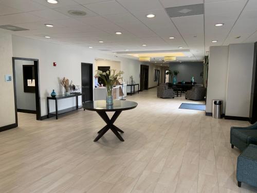 a lobby with a table with a vase of flowers on it at Holiday Inn Express Hotel & Suites Hermosa Beach by IHG in Hermosa Beach