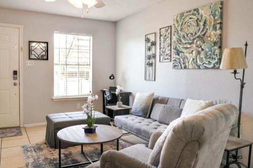 a living room with a couch and a table at Congeniality and Comfort. All the essentials with class, 2 nights? 2 weeks? Stay, relax, work, or go out for fun. in Arlington