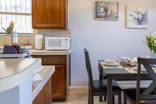 a kitchen with a table and a microwave at Congeniality and Comfort. All the essentials with class, 2 nights? 2 weeks? Stay, relax, work, or go out for fun. in Arlington