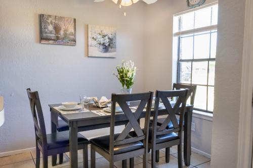 a dining room with a black table and chairs at Congeniality and Comfort. All the essentials with class, 2 nights? 2 weeks? Stay, relax, work, or go out for fun. in Arlington