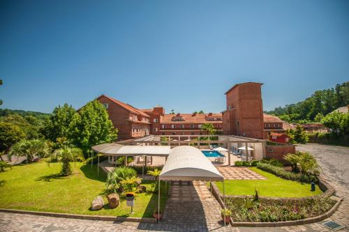 a view of a house with a large umbrella at Farina Park Hotel in Bento Gonçalves