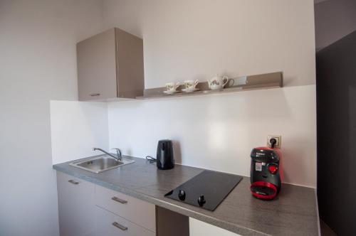 a kitchen with a counter top with a laptop on it at Avyssos Residents in Kalamaki
