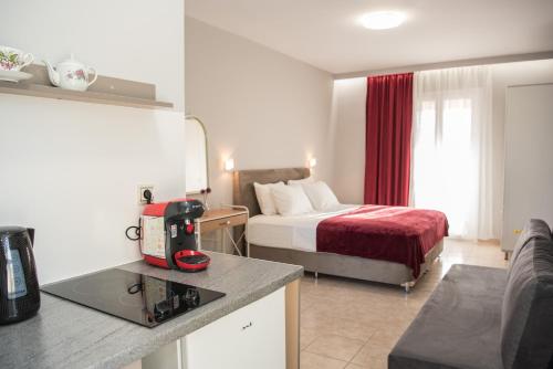 a small hotel room with a bed and a kitchen at Avyssos Residents in Kalamaki