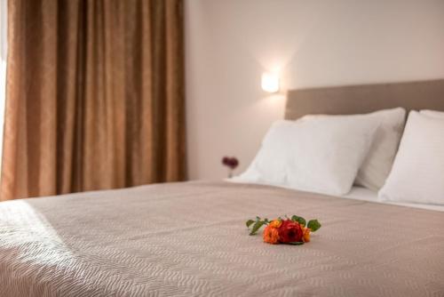 a flower on a bed in a hotel room at Avyssos Residents in Kalamaki