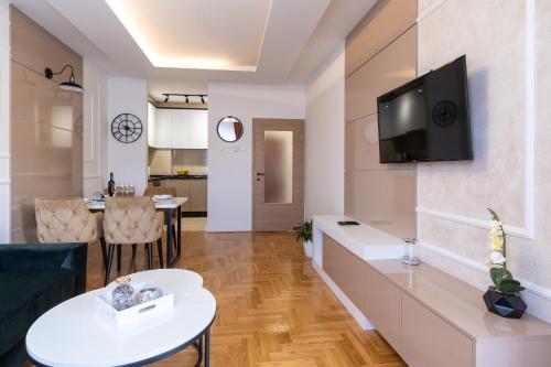 a living room with a tv on a wall at Apartman Vanilla Sky in Trebinje