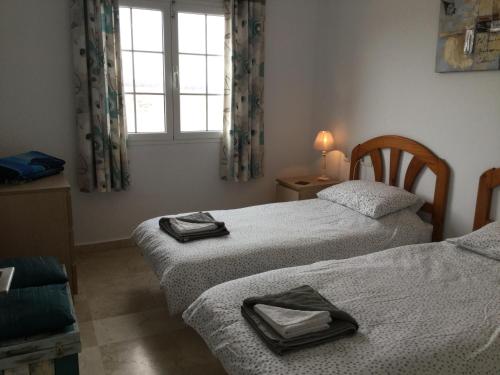 A bed or beds in a room at Lovely 2 Bedroom Holiday Apartment in Central Caleta de Fuste
