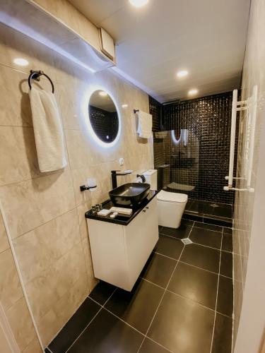 a bathroom with a sink and a toilet and a shower at Luxury Duplex Suites - City Center in Tbilisi City