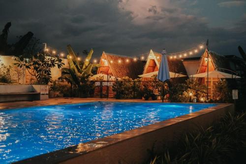 a resort with a swimming pool at night at Urban Oasis Resort, Tarlac in Tarlac