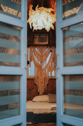 a window view of a bedroom with a chandelier at Urban Oasis Resort, Tarlac in Tarlac
