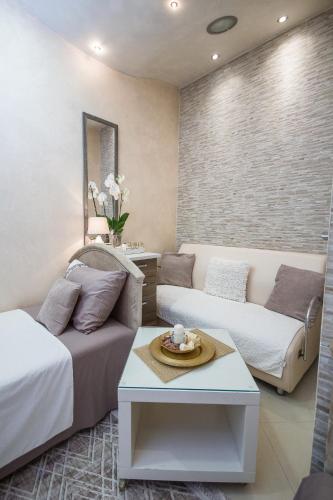 a living room with a couch and a table at Apartments Lidija in Petrovac na Moru
