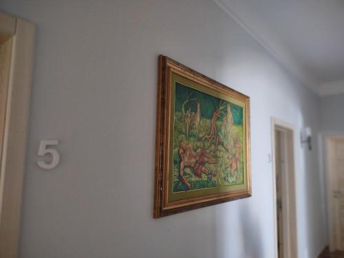 a painting on a wall with a clock on it at B&B Vacanze Salento in Torre San Giovanni Ugento