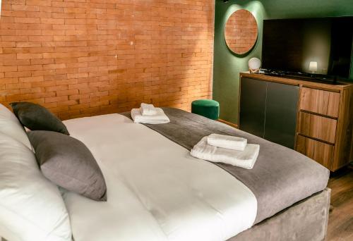 a bedroom with a large bed with towels on it at Luxury Duplex Suites - City Center in Tbilisi City