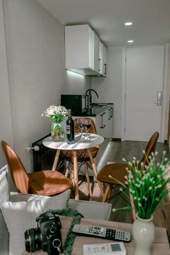 a kitchen with a table with a bottle of wine at Luxury Duplex Suites - City Center in Tbilisi City