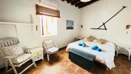 a bedroom with a bed and two chairs in it at Casa Can Pep Tauet in San Ferrán de ses Roques