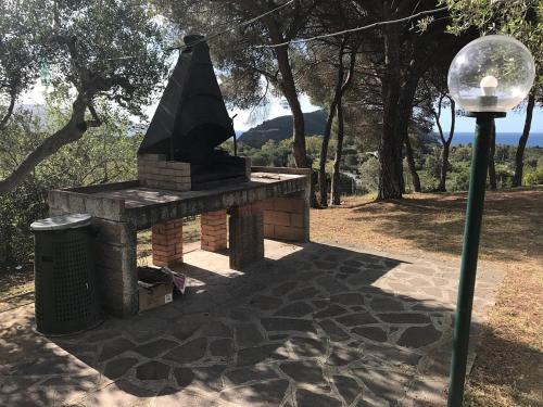 a brick fireplace sitting next to a street light at Villa Conti Residence in Lacona