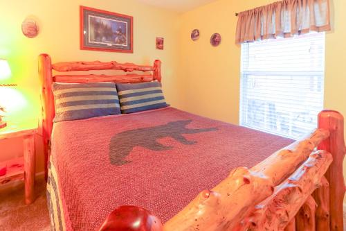 a bedroom with a wooden bed in a room with a window at Little Bear Retreat 1 in Helen