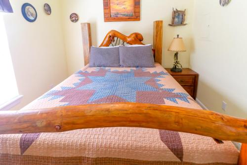 a bedroom with a wooden bed with a quilt on it at Little Bear Retreat 1 in Helen