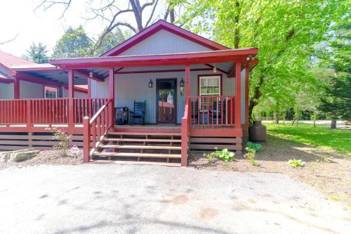 a small red house with a porch and stairs at Little Bear Retreat 1 in Helen