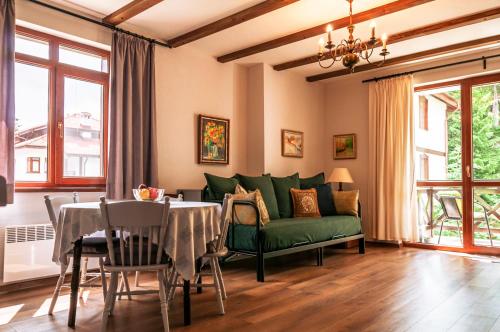 a living room with a green couch and a table at "Моето Любимо Място", Смолянски езера - "My Favorite Place", Smolyan lakes in Smolyan